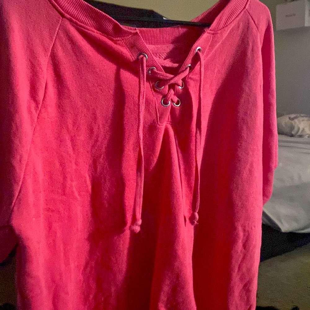It’s a pink short sleeve sweatshirt open neck.